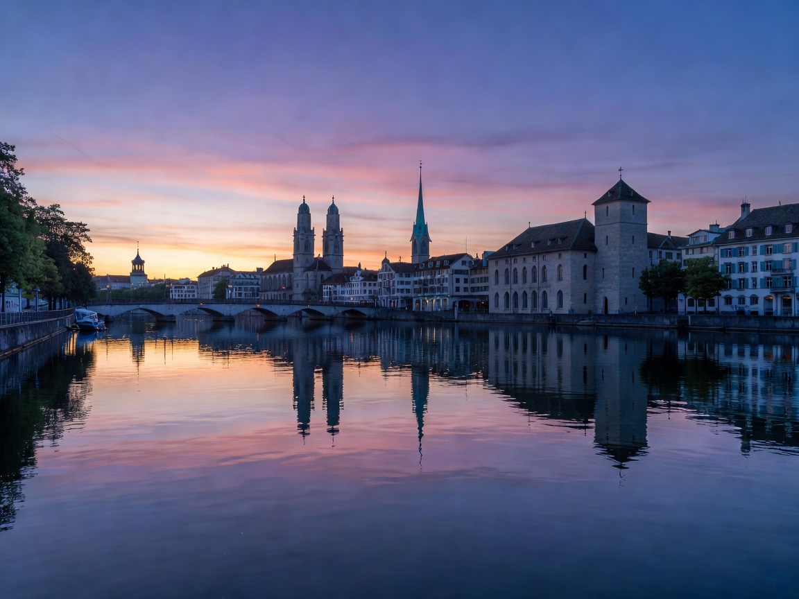 Zurich city skyline along the Limmat river with Grossmünster church towers